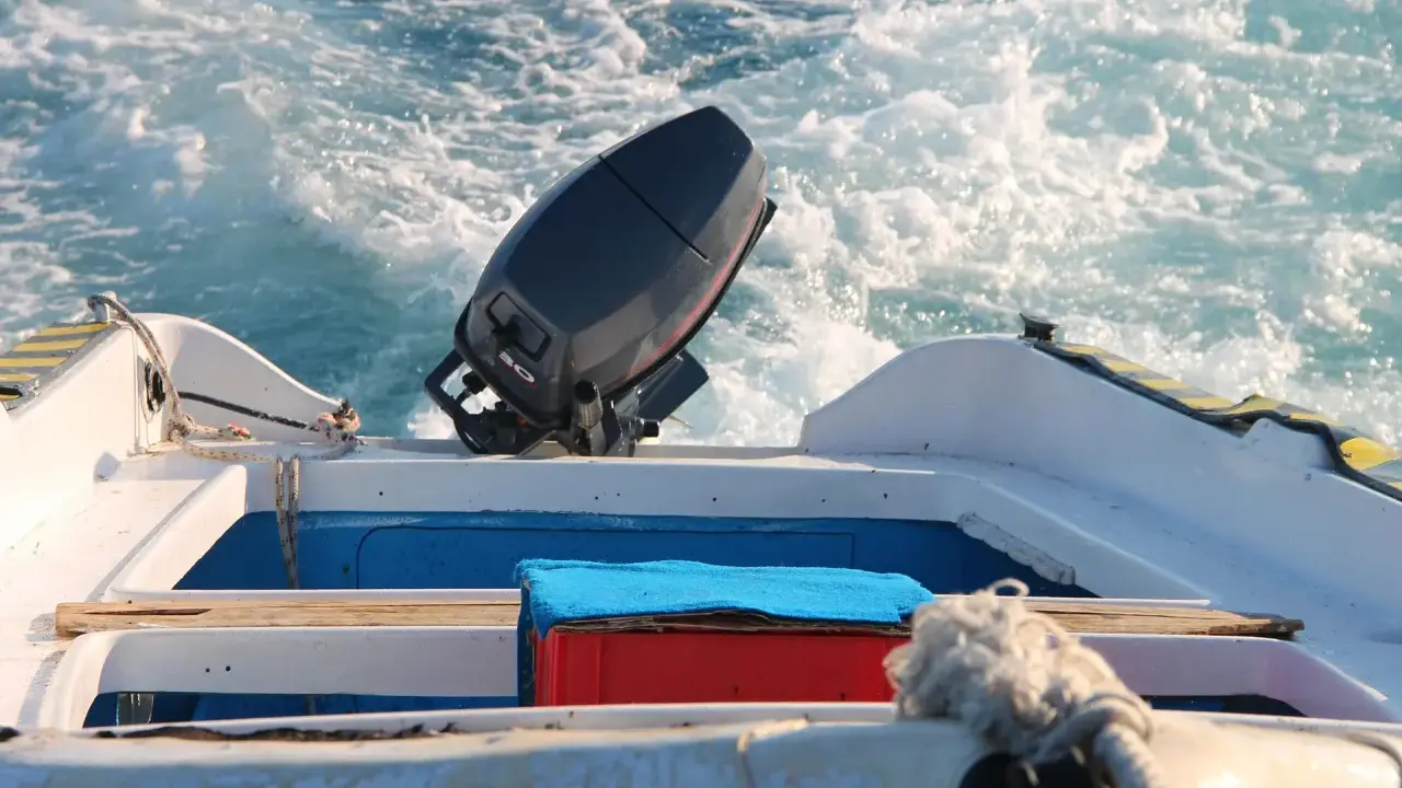 Moteur hors-bord 2 temps sur un bateau en mouvement. Un entretien régulier assure la fiabilité pour vos sorties en mer.
