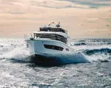 Un bateau blanc fend les vagues, le moteur de 20 cv propulsant l'embarcation à pleine vitesse.